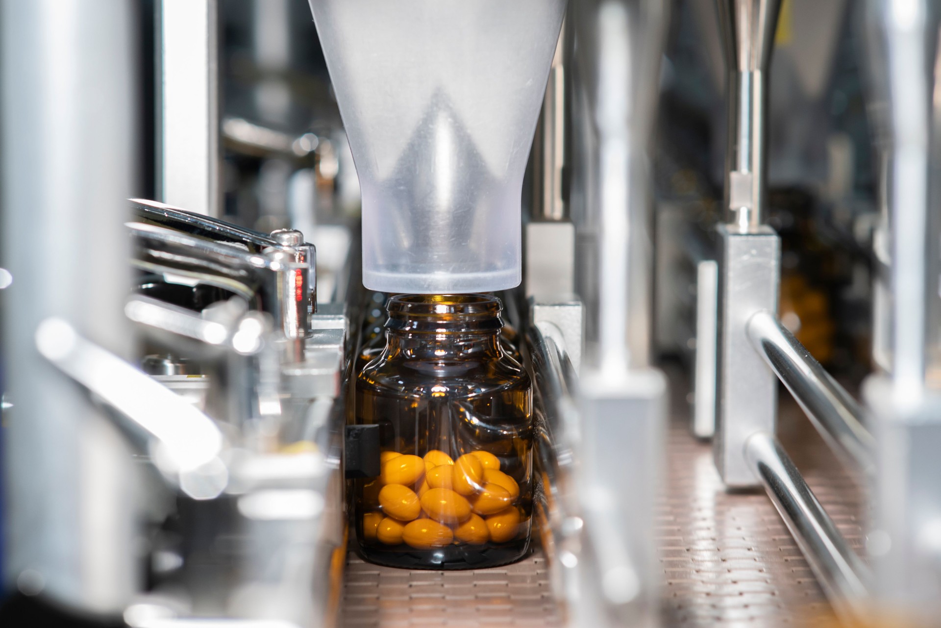 Drug capsules on conveyor belts at modern pharmaceutical factories
